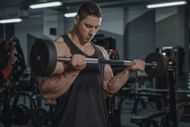 Straight bar curls is an easy biceps curl exercise. (Photo via Pexels/Tima Miroshnichenko)